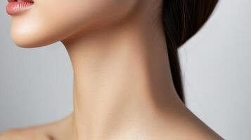 Close-up view of a woman's smooth neck and upper chest. photo