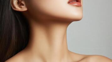Close-up view of a woman's smooth neck and chest. photo