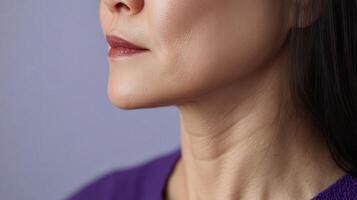 Close-up profile view of a woman's aging neck and jawline. photo