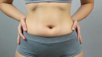 Close-up view of a woman's midsection with a noticeable belly. photo