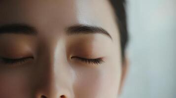 A woman with closed eyes and a closed mouth photo