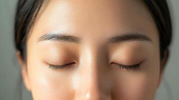 Close-up view of a woman's serene facial features. photo