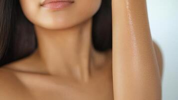 Closeup of a woman's arm and face with smooth skin. photo