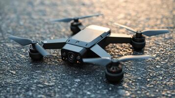Small, dark drone on a paved surface. photo