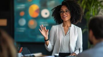 A woman presents data charts during a business meeting photo