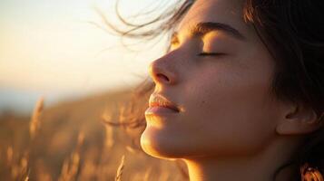 Close-up portrait of a woman breathing deeply in golden light. photo