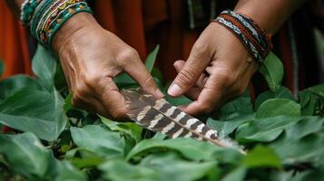 Close-up view of hands holding a feather amidst foliage. photo