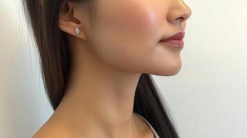 Close-up profile view of a person wearing delicate earrings. photo