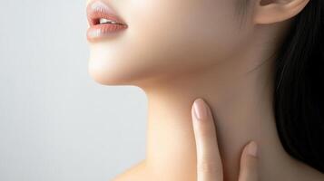 Close-up profile view of a young woman's neck and jawline. x photo