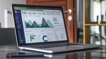 Modern laptop displaying financial data graphs. photo