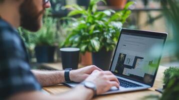 Man working on a laptop outdoors at a cafe. photo