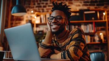 Smiling person using laptop in cozy home setting. photo