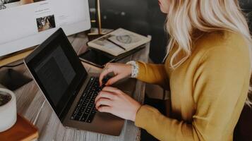 Woman working at a laptop computer, focused on tasks. photo