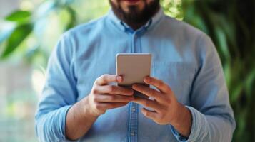 Bearded Man Holding a Smartphone and Concentrating on Its Screen photo