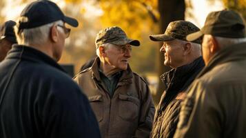 Several older men are engaging in a focused conversation outdoors photo