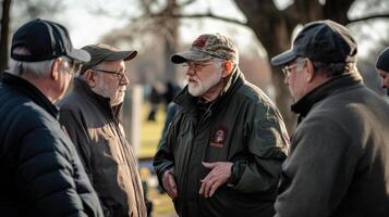 A group of older men in conversation outside in daytime photo