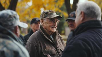 A group of older men talking outside on a sunny day photo
