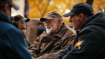 A group of senior men gathered talking outdoors together photo