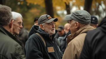 Several older men in casual clothing are conversing outdoors together photo