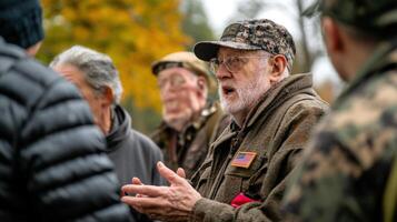 A group of older veterans appear to be conversing outdoors photo