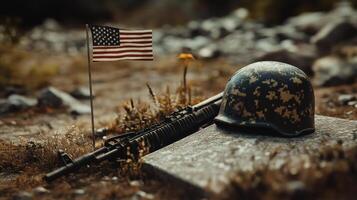 A fallen soldiers helmet and weapon beside the national flag photo
