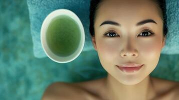 Relaxed woman with green tea, spa treatment. photo