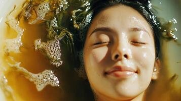Relaxing individual in a therapeutic seaweed bath. photo