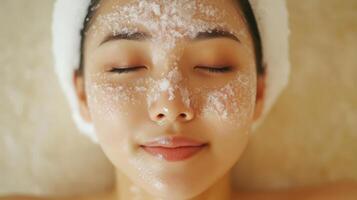 Close-up of a relaxed woman receiving a facial treatment. photo