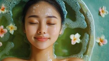 Peaceful, serene woman relaxing in a soothing spa bath. photo