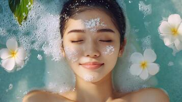 Relaxed woman enjoying a spa facial treatment. photo