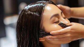 Close-up view of a person receiving a hair treatment. b photo