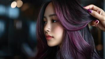 Close-up profile view of a young woman with vibrant purple highlights. photo
