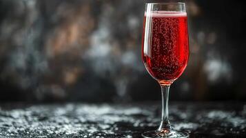 A tall glass of ruby red liquid with bubbles photo