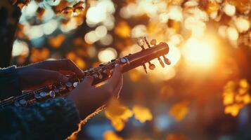 Hands play a small wind instrument during a sunny autumn day photo
