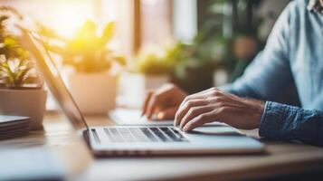 A person is typing on a laptop with bright sunlight photo