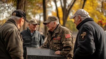A group of veterans gathered near a memorial outdoors photo