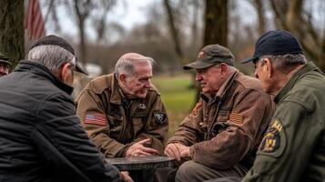 Group of senior men conversing outdoors around a table photo