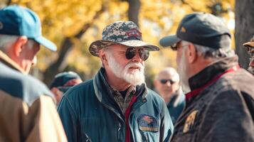 A group of older men are engaged in an outdoor conversation photo