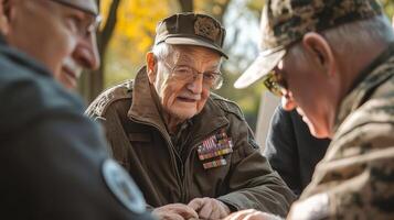 Several older men in uniform sitting together outside talking photo