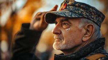 An elderly man in a military uniform saluting in profile photo