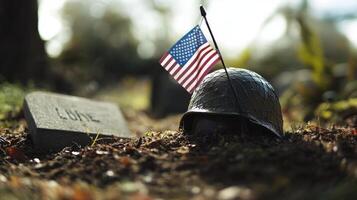 An American flag rests by a war helmet in soil on a grave photo