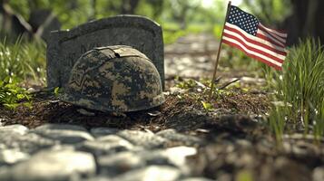 A military helmet rests near a grave with a small American flag photo