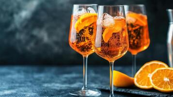 Three champagne flutes filled with sparkling orange cocktails and citrus fruits photo