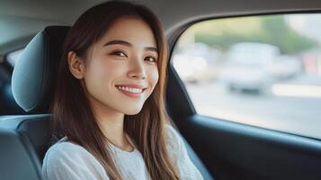 Smiling woman seated in a car's back seat. photo