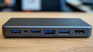 Gray metallic device with many ports on a wooden surface. photo