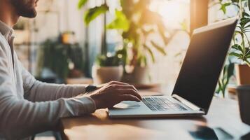 Close up of a person working on a laptop in a bright space. photo