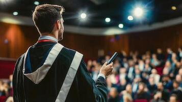 A graduate delivers a speech to a large audience. photo