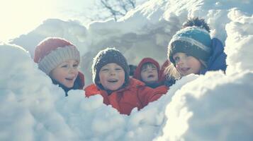 Playful children concealed in a snow fort. photo