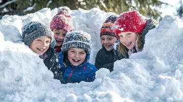 Five children in a snowy hideaway. photo
