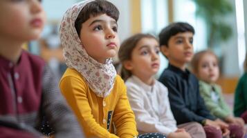 Young children attentively seated in a row. photo